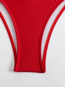Detail view of red monokini bottom showing premium stitching and white inner lining