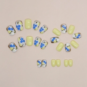 Short lemon yellow floral press-on nails with blue flower patterns in 24 pieces set