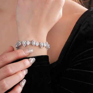 Close-up of sparkling pear and oval cut zircon bracelet on a model wrist