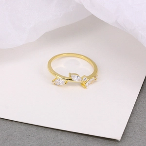 Detail view of gold leaf ring showing S925 hallmark and sparkling zircon crystals