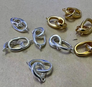 Detail view of S925 sterling silver interlocking jewelry clasps in gold and silver