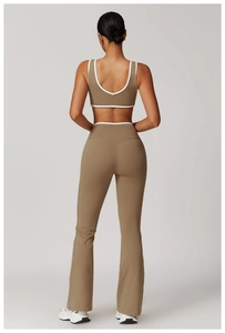 Rear view of high-waist flared yoga pants and backless sports bra with white piping