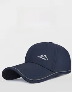 Detail of navy sport cap featuring mountain embroidery and reflective brim edge