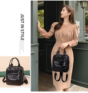 Detail showing versatile black leather backpack with multiple zippers and handbag handle