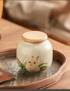 Detail of Ru Kiln ceramic tea canister with wooden lid and cute rabbit illustration