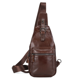 Front view of a brown vintage leather chest bag with zipper pockets and adjustable strap