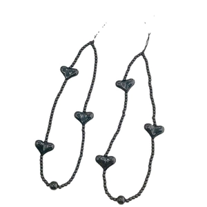 Minimalist black beaded phone wrist strap set featuring polished heart-shaped charms