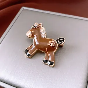 Vintage horse brooch with brown enamel, white zircons, and gold snowflake detailing