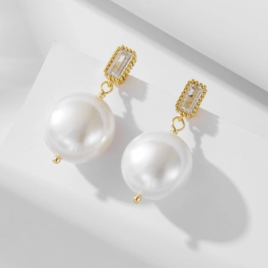 Detail of vintage s925 silver earrings with large pearls and rectangular zircons
