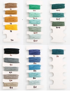 Detailed color chart of handmade tassels showing yellow green gray and blue embroidery threads