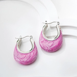 Close-up of silver U-shaped earrings with pink marble enamel inlay on white stand