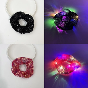 Detail showing pink and black sequin hair scrunchies with glowing LED light effects