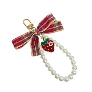 Cute strawberry keychain with red plaid bow and pearl wristlet on golden clasp