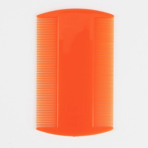 Close-up of orange plastic flea comb with double-sided fine teeth for pet grooming