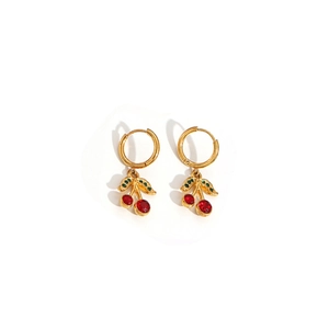 Detail of gold cherry hoop earrings featuring red gemstones and green leaf accents