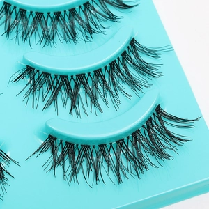 Five pairs of natural black manga eyelashes arranged on a cyan tray for a dramatic look