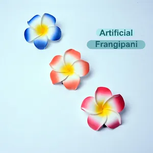 Three gradient colored frangipani flower hair clips in blue, orange, and pink colors