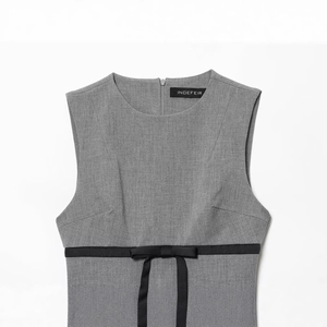 Sleeveless grey mini dress featuring a satin black bow belt and subtle twill texture