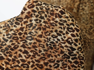 Close-up of leopard print fabric detail showing soft texture and premium weave pattern