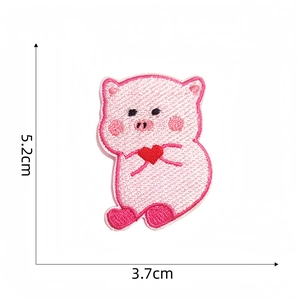 Detail showing cartoon pink pig embroidery patch with heart and 5.2x3.7cm measurements