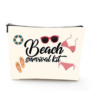 Detail of linen makeup bag with black zipper and beach survival kit illustration
