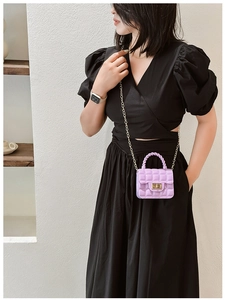 Mini purple quilted jelly bag with gold chain strap shown on a model for casual summer style