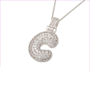 Macro shot of silver hip hop pendant letter C with pave set cubic zirconia stones