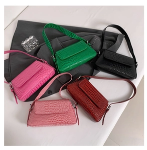 Top view of sleek crocodile pattern shoulder bags in green, black, red, and pink colors