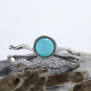 Close-up of S925 silver wave rings set with natural turquoise and sparkling zircon stones