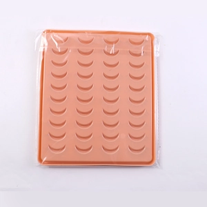 Detail view of orange silicone mold with crescent moon shapes in plastic packaging