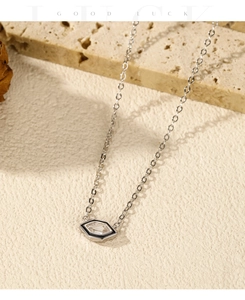 Detail of s925 silver necklace with hexagonal pendant and black enamel border