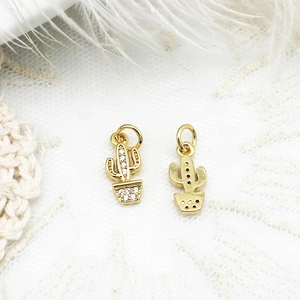 Macro detail of gold-plated cactus pendants with micro-pave crystals for jewelry making