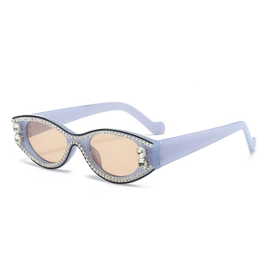 Chic lavender cat-eye sunglasses with sparkly rhinestones and orange-pink lenses