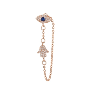 Detailed close-up of rose gold evil eye and Hamsa hand chain earrings with blue stones