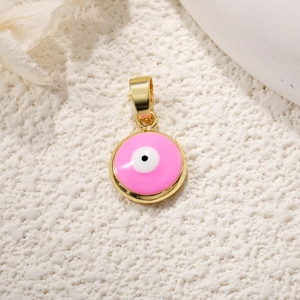 Detailed macro view of a round pink enamel evil eye pendant with gold plated frame