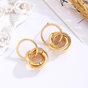 Detail view of interlocking golden rings design on aesthetic decorative background