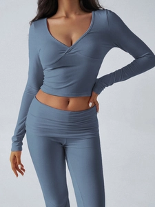 Detail of blue knit yoga set featuring V-neck wrap top and high-waisted wide-leg pants