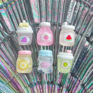 Close-up of six miniature resin fruit juice and jam bottles with holographic background
