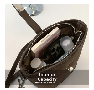 Detail of spacious dark brown suede bucket bag showing large interior capacity