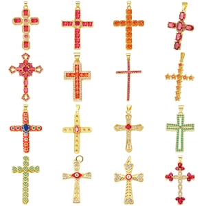 Collection of 16 gold cross pendants with colorful zircons and enamel on white background