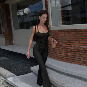 Detail view of black high-stretch slim fit tank top and flared pants set for women