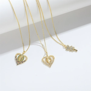 Detailed view of gold bear and heart pendants with sparkling cubic zirconia inlay