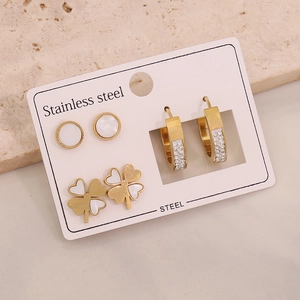 Detail of three-pair stainless steel earring set with clover, pearl, and rhinestone