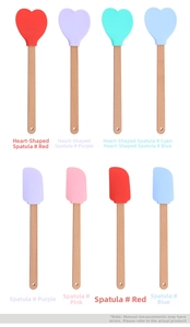Close-up of heart-shaped silicone spatulas with wooden handles in various pastel colors