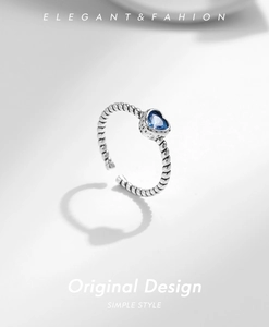 Detail of S925 sterling silver twist ring with a heart-shaped blue zircon stone