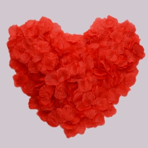 Artificial red silk rose petals for wedding decoration arranged in a heart shape