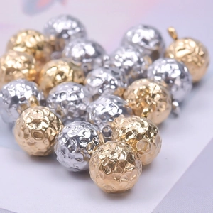 Macro shot of 18k gold and silver 304 stainless steel hammered texture ball beads