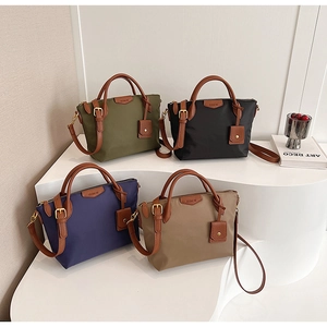 Macro shot of nylon tote bags in four colors with leather details and adjustable straps