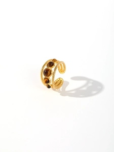 Detail of vintage gold open ring with tiger eye stones and twisted rope textures