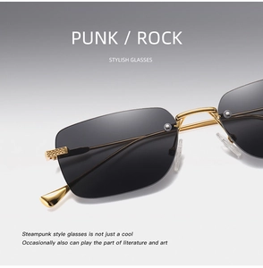 Close-up of rimless steampunk sunglasses with grey lenses and gold metal temples